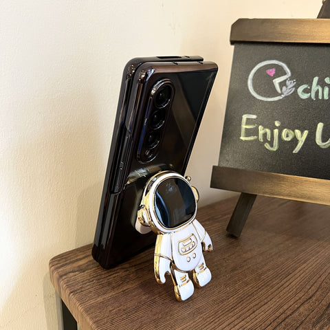 Fashionable Astronaut Stand Phone Case for Samsung Galaxy Z Fold 4 and Galaxy Z Fold 3.